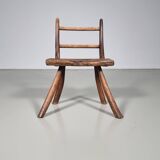 Rustic Wabi-Sabi style accent chair in dark curved hardwood, 1900s.