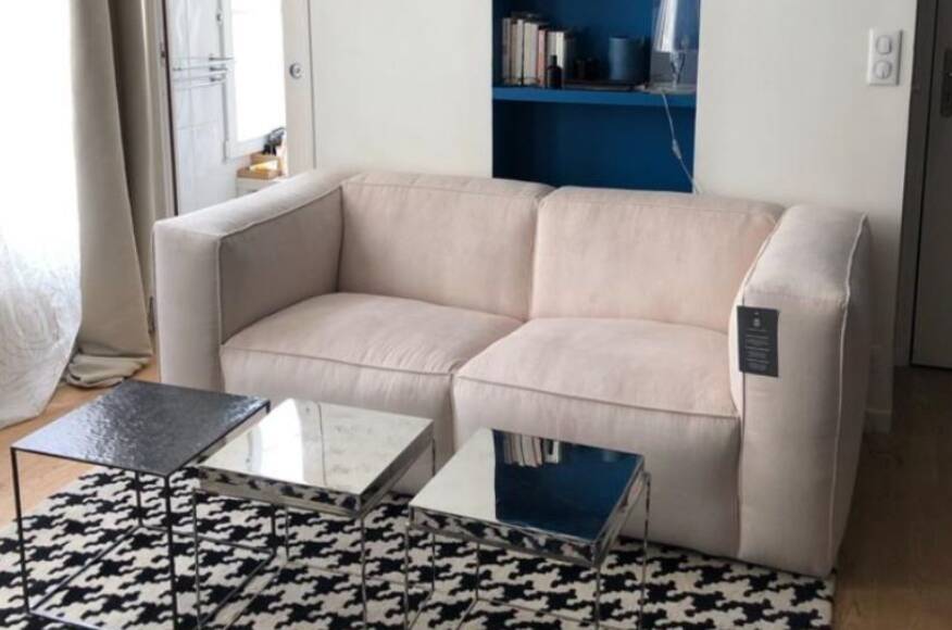 Beige corduroy two-seater sofa