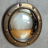 50s French porthole-style witch mirror with convex glass.