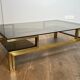 Modernist coffee table in brass and smoked glass tops by Guy Lefèvre for Maison Jansen.