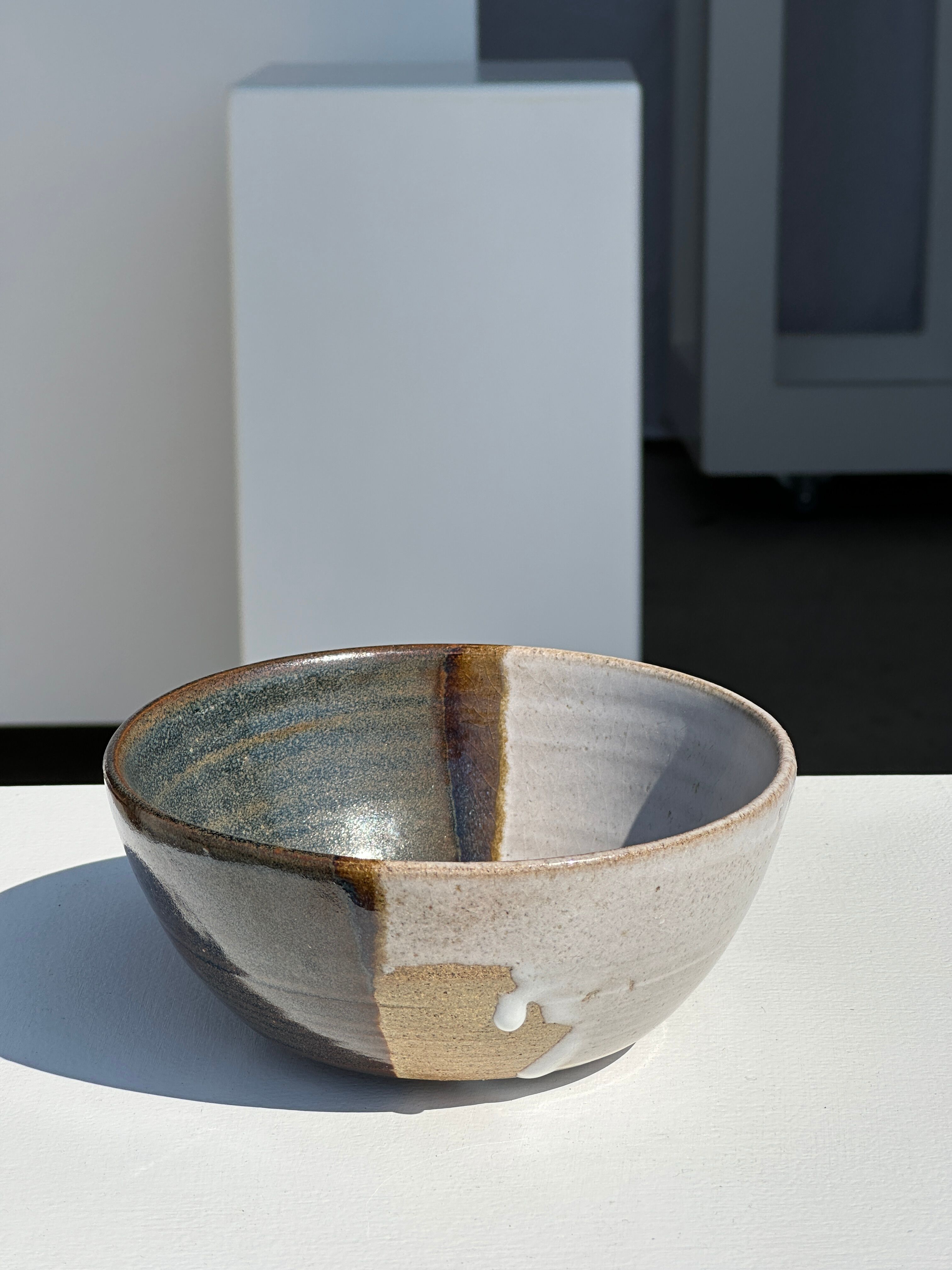 White and glossy brown two-tone ceramic bowl, matt earth