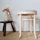 Vintage curved wooden stool in Baumann style, striped fabric seat.