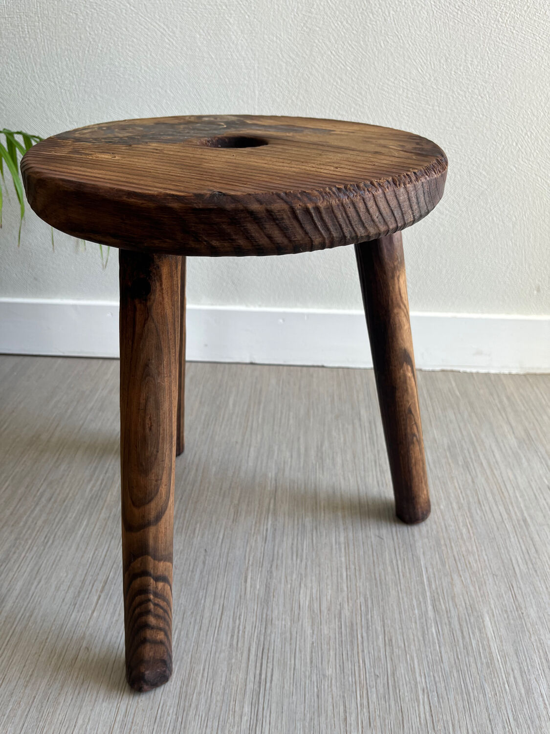 Three-legged wooden stool
