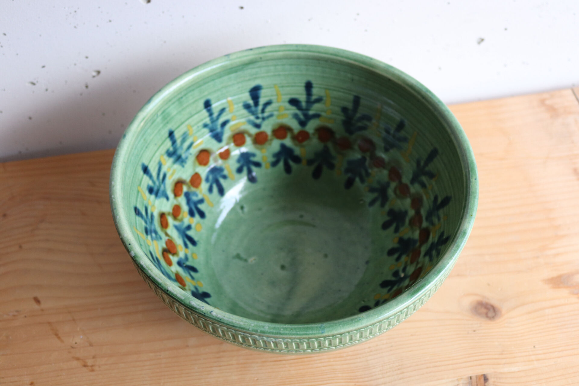 Large glazed ceramic salad bowl with a floral design.