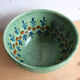 Large glazed ceramic salad bowl with a floral design.