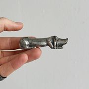 Antique metal knife rest in the shape of a dog.