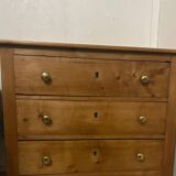 Rustic English pine chest of drawers with porcelain knobs.