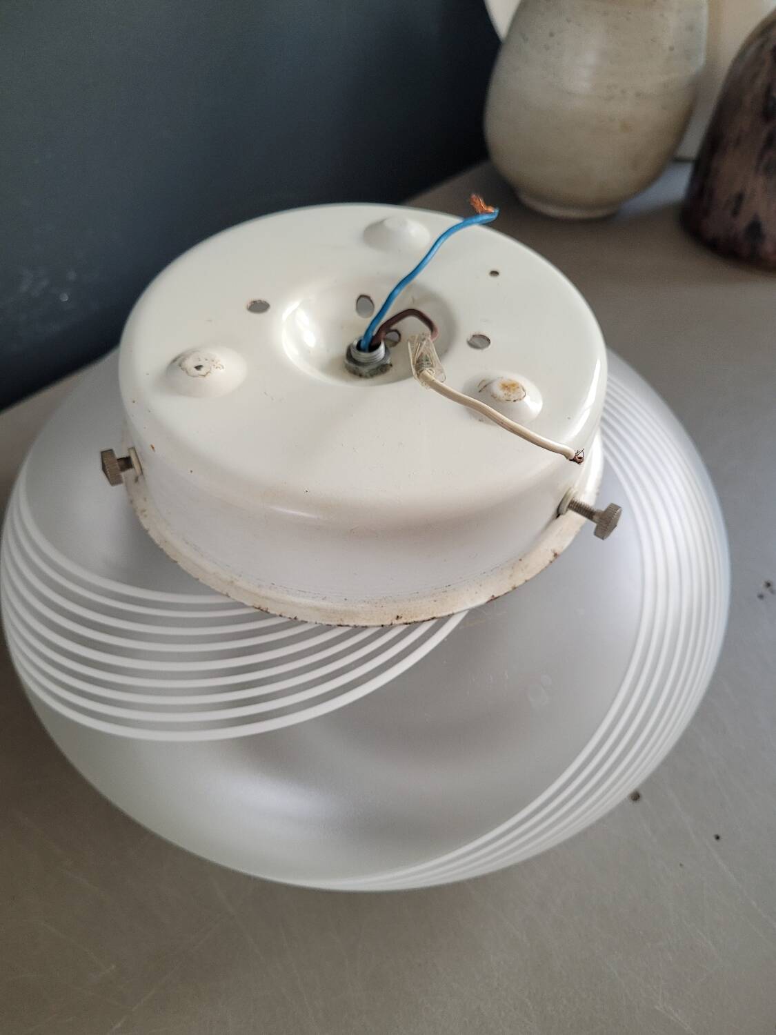 Frosted glass globe ceiling light with spiral patterns.