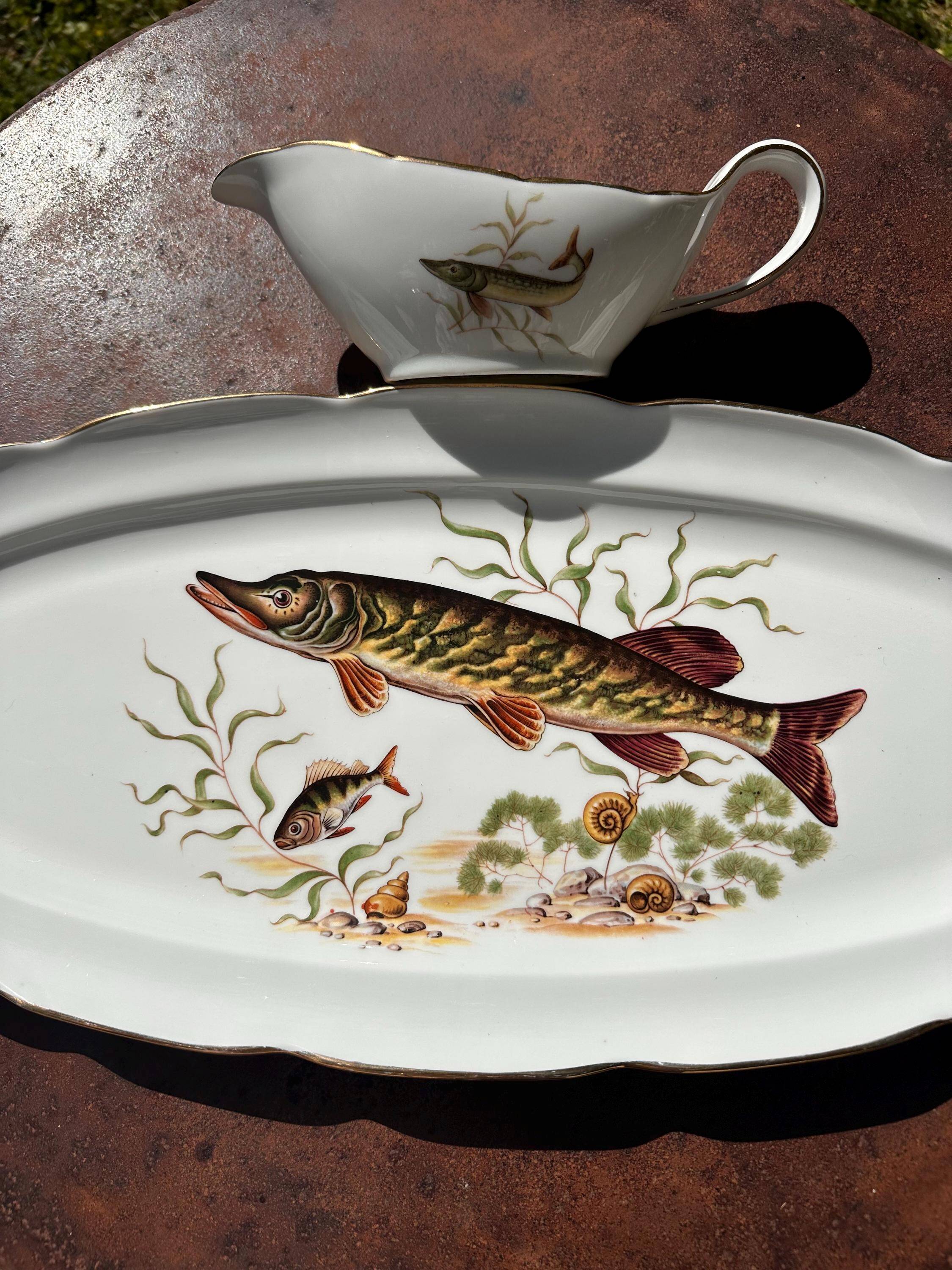 Large fish platter and its vintage porcelain sauce boat, decorated with pike.