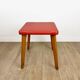 Wooden stool with red faux leather from the 1950s.