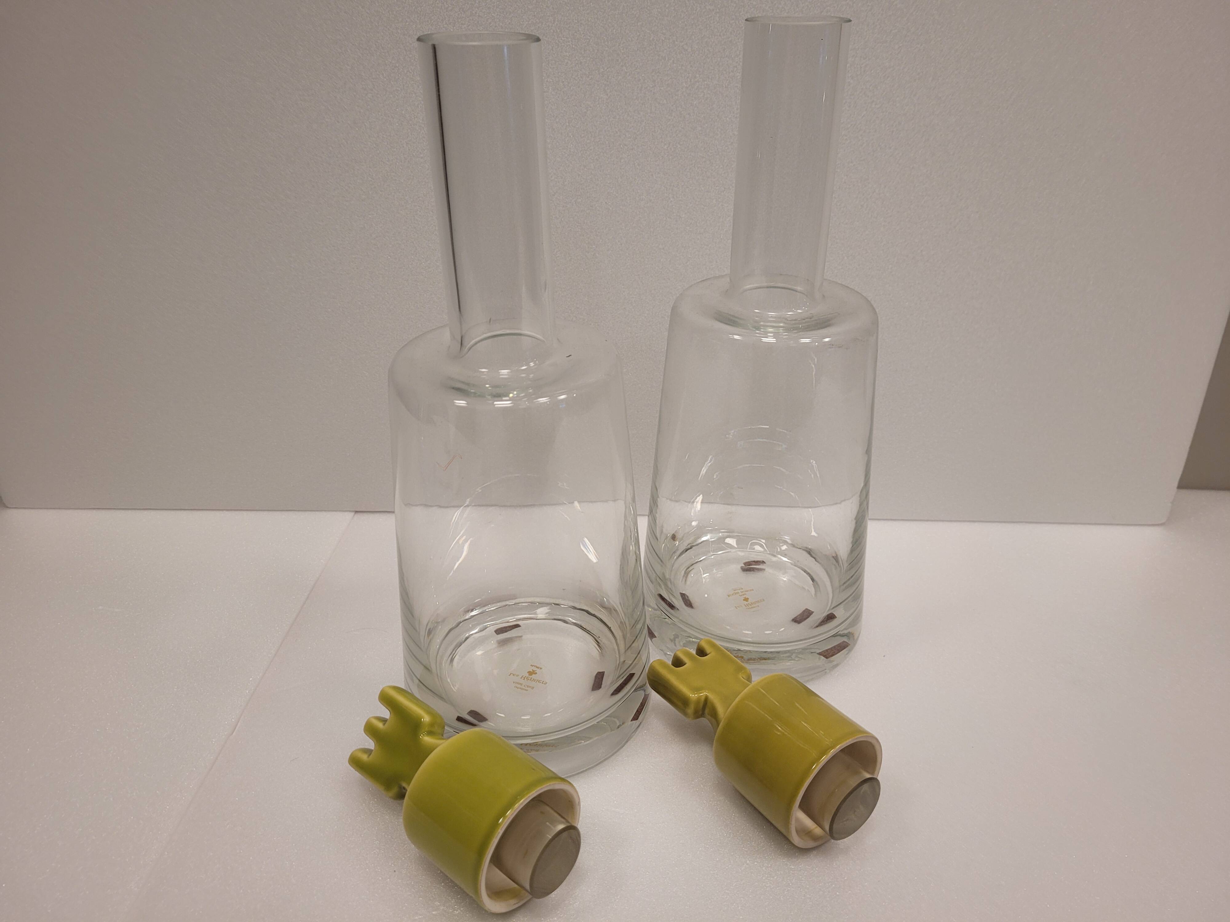 pair of decanters, bottles or jars, made in crystal with a ceramic tap enameled in green color