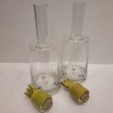 pair of decanters, bottles or jars, made in crystal with a ceramic tap enameled in green color