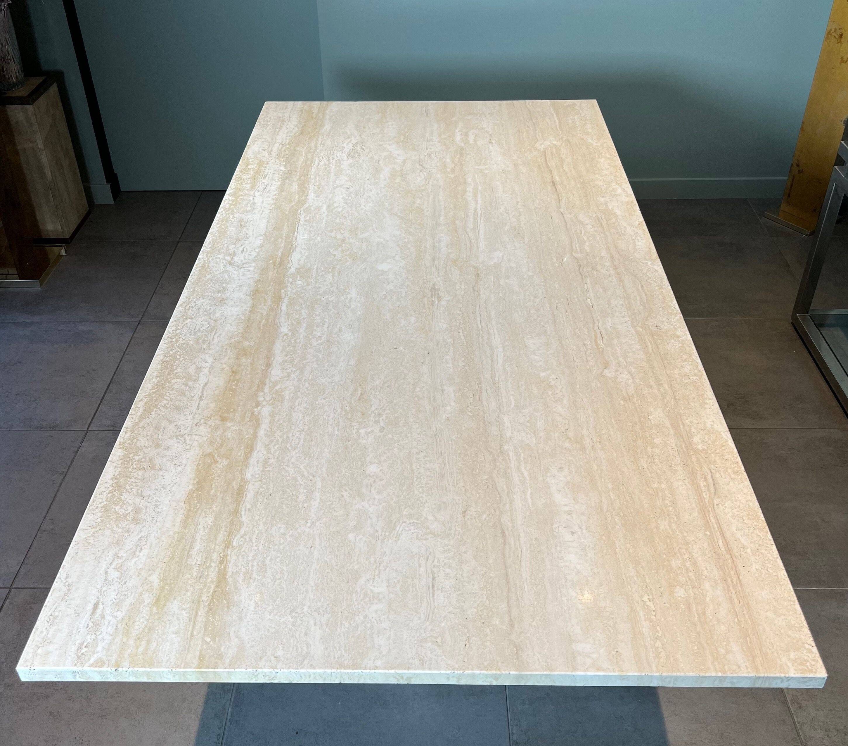 Dining table in travertine and brass. French work. Around 1970.