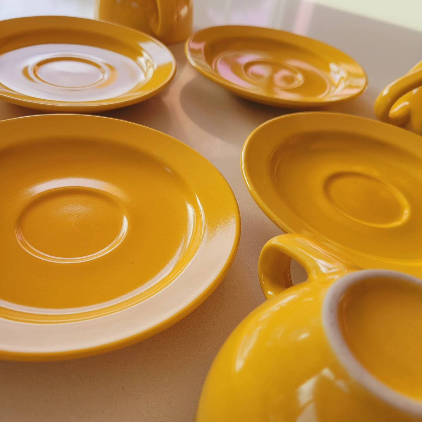 4 yellow cups and saucers