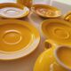 4 yellow cups and saucers