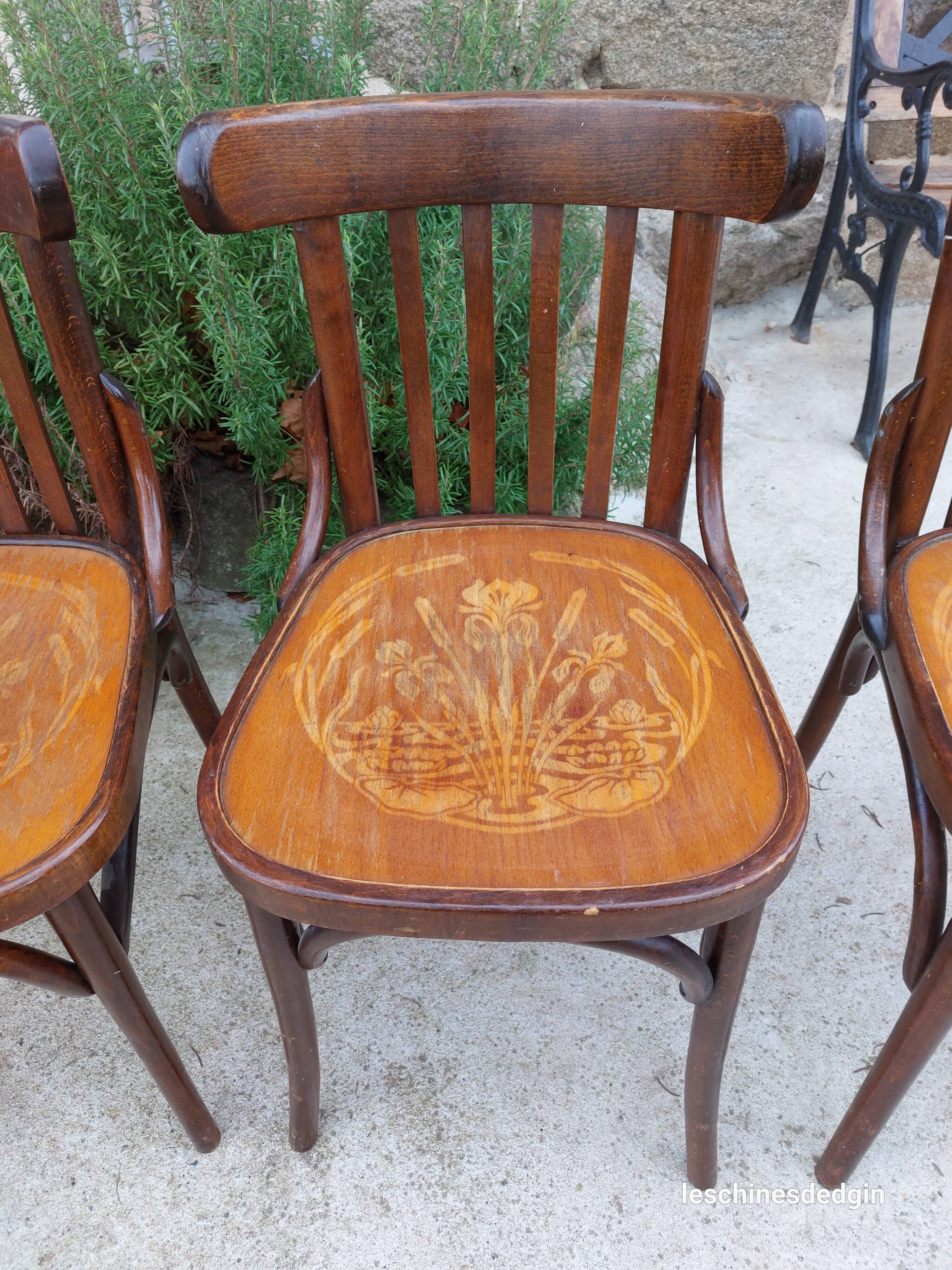 4 bentwood bistro chairs with a pattern on the seat