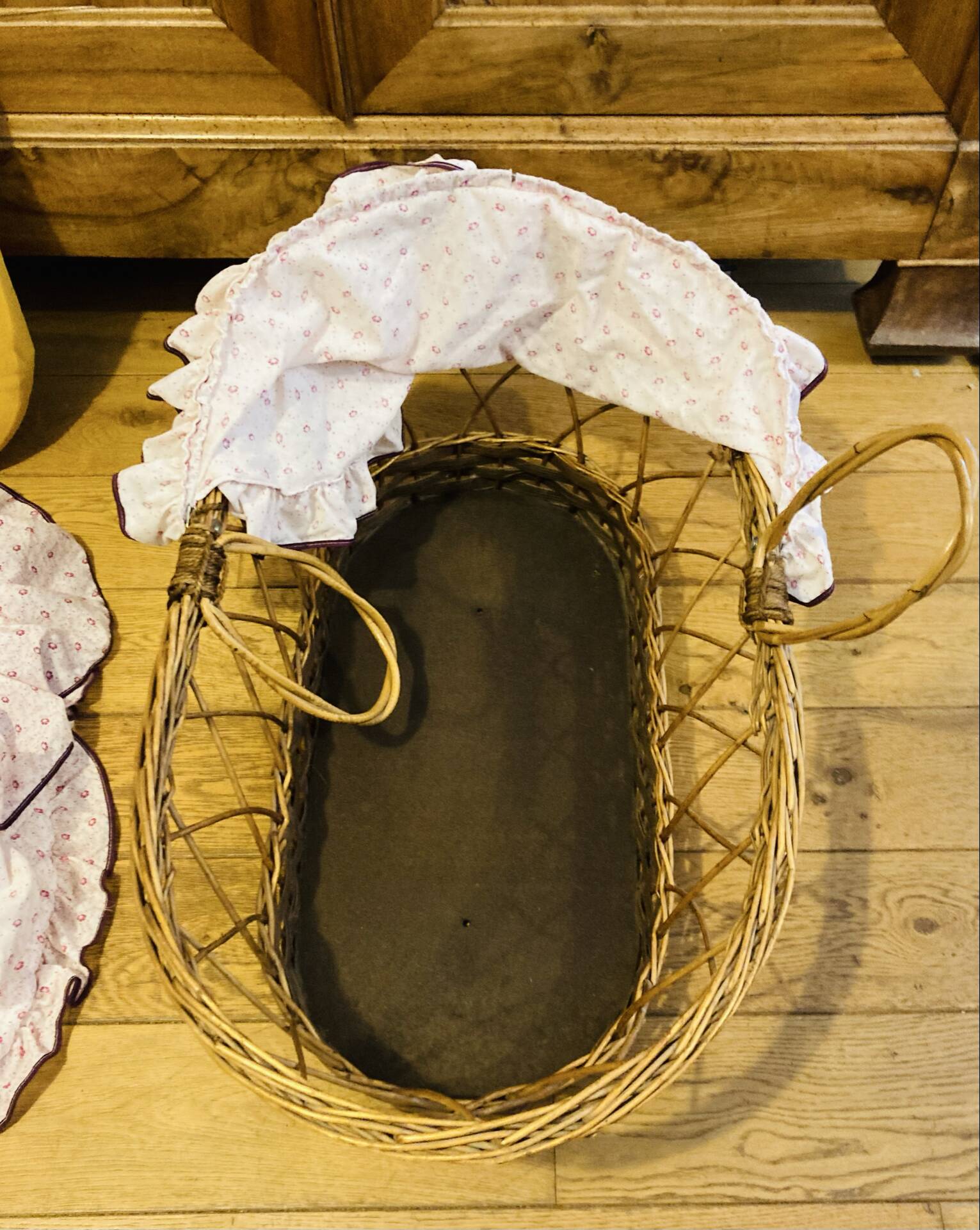 1960s wicker cradle with mattress and drapes.