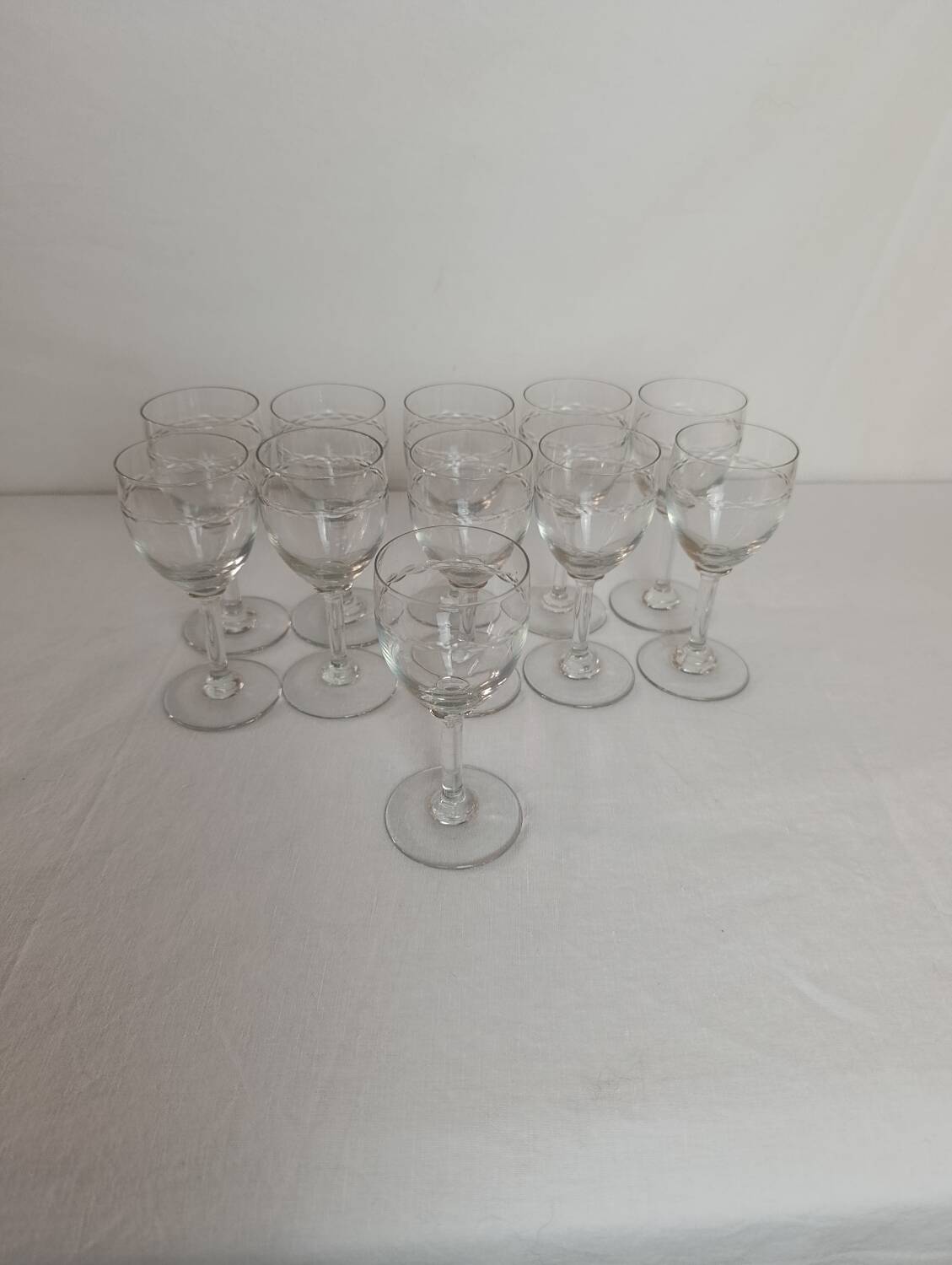 Set of 11 antique engraved crystal liqueur glasses.