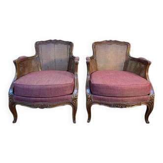 Paire de fauteuils - bergères de style Louis XV en cannage