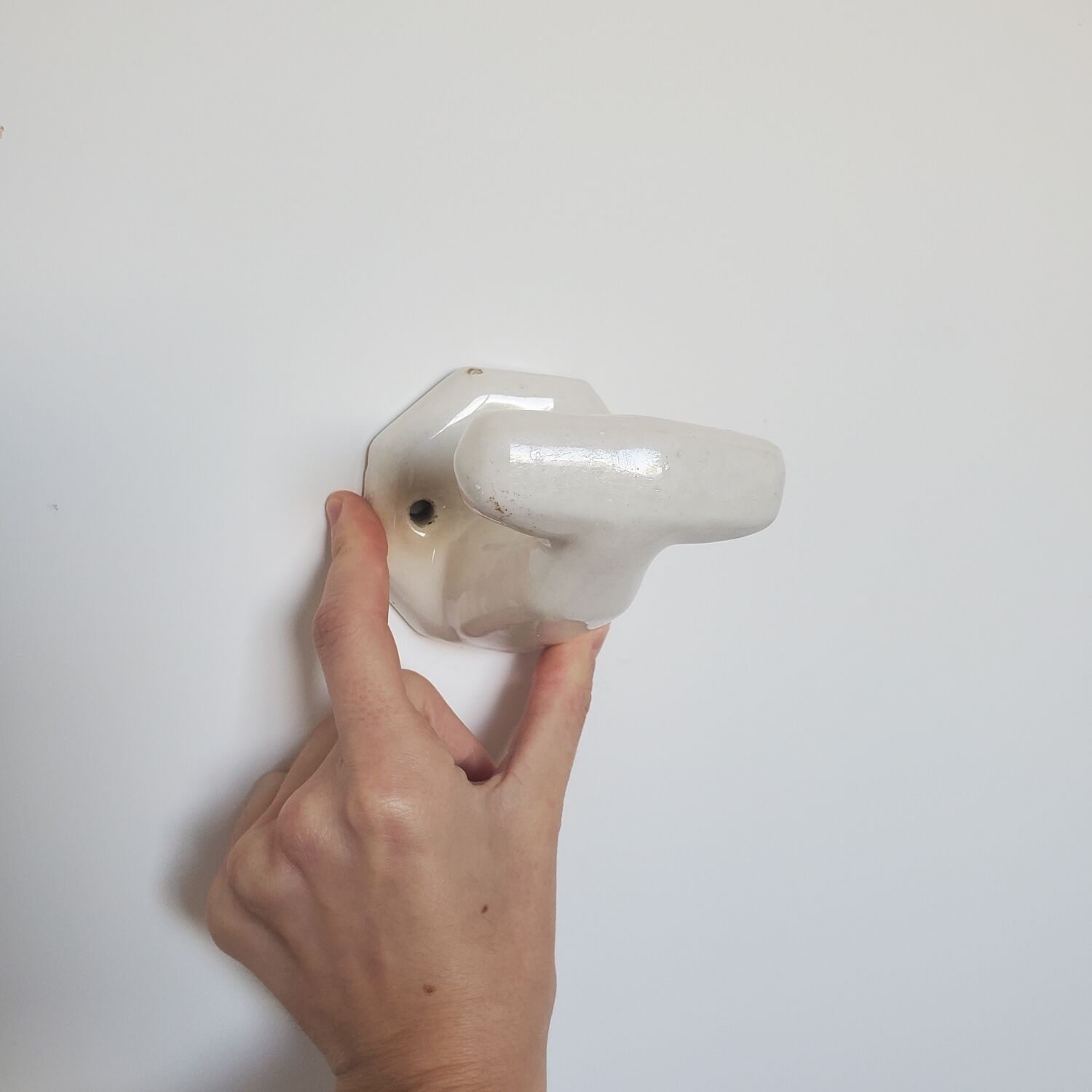 Trio of white porcelain hooks