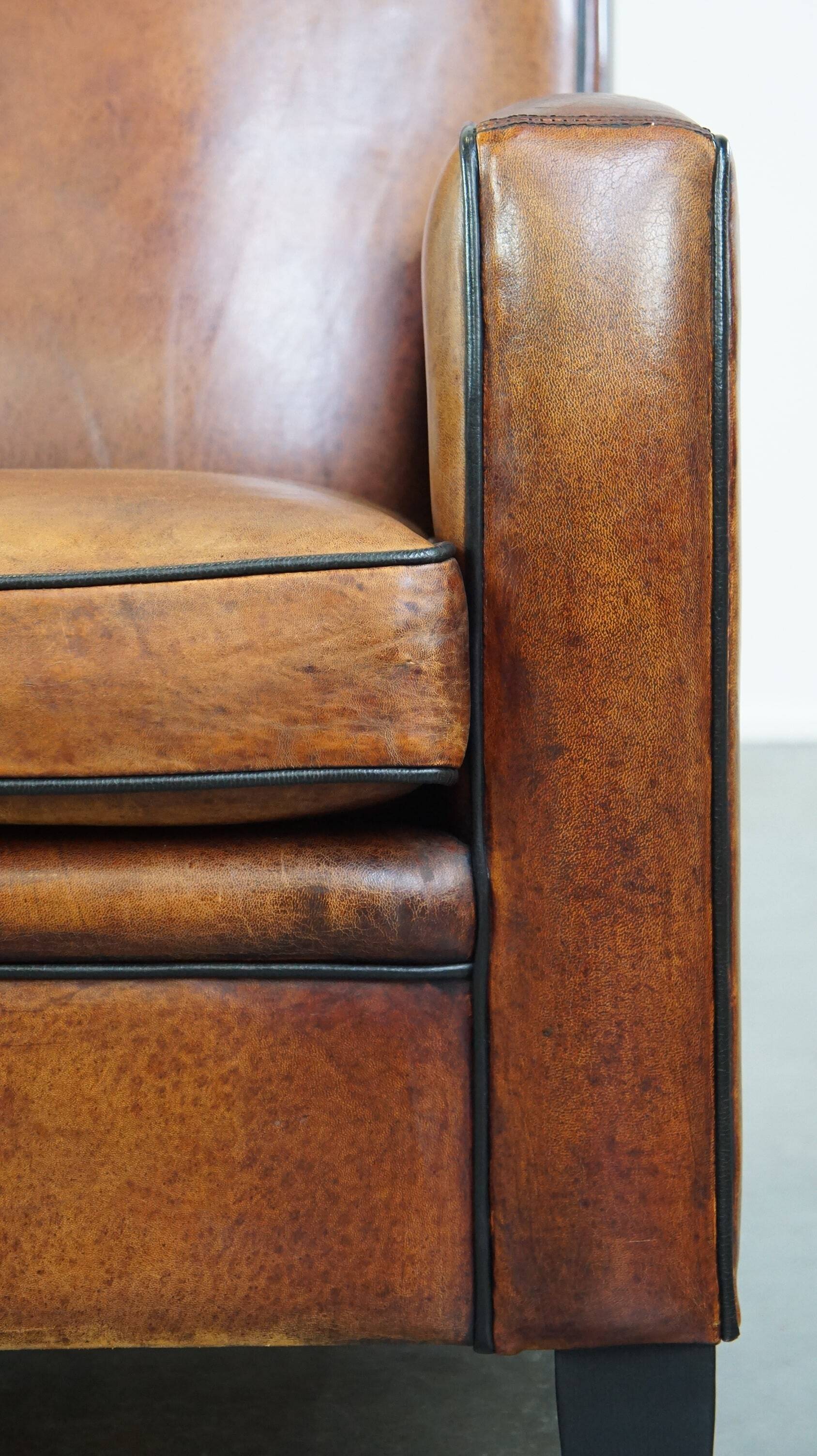 Art Deco design sheepskin leather armchair with a stunning patina