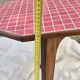 Small Scandinavian side table with wood and pink tiles, with tapered legs.
