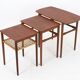 Rare set of three teak nesting tables with cane magazine rack / side tables / mid-century Danish modern design / 1950s / 1960s