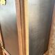 Vintage wooden wardrobe with matte cast iron color hanging rail