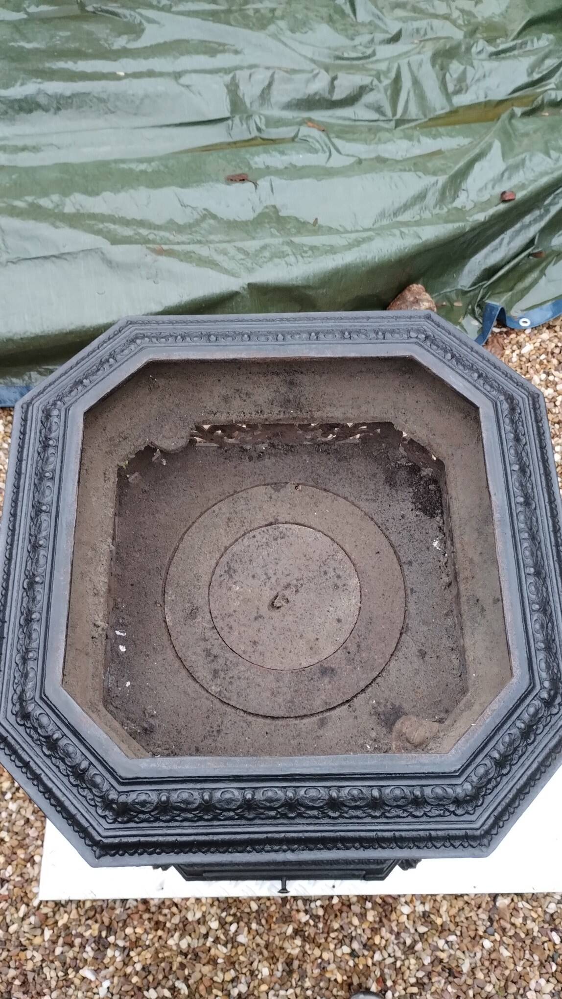 Black cast iron wood burning stove with solid brass handle.