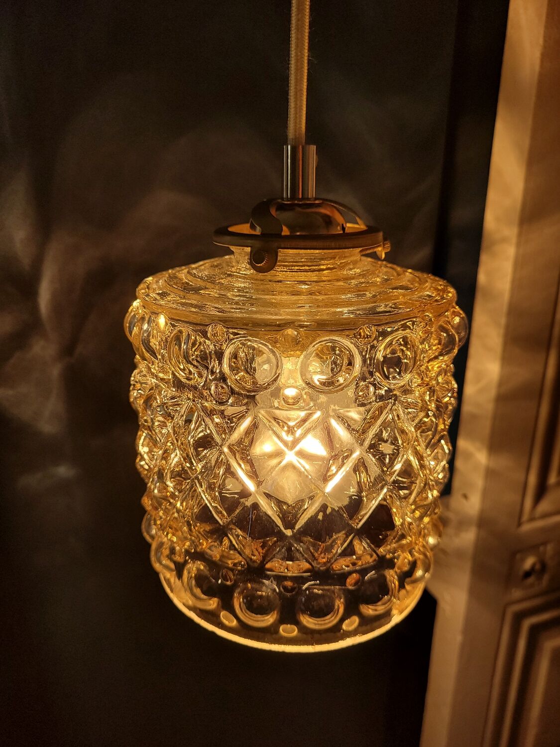 Moulded glass lamp with a cubic-spherical relief design.
