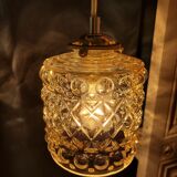 Moulded glass lamp with a cubic-spherical relief design.