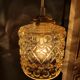 Moulded glass lamp with a cubic-spherical relief design.