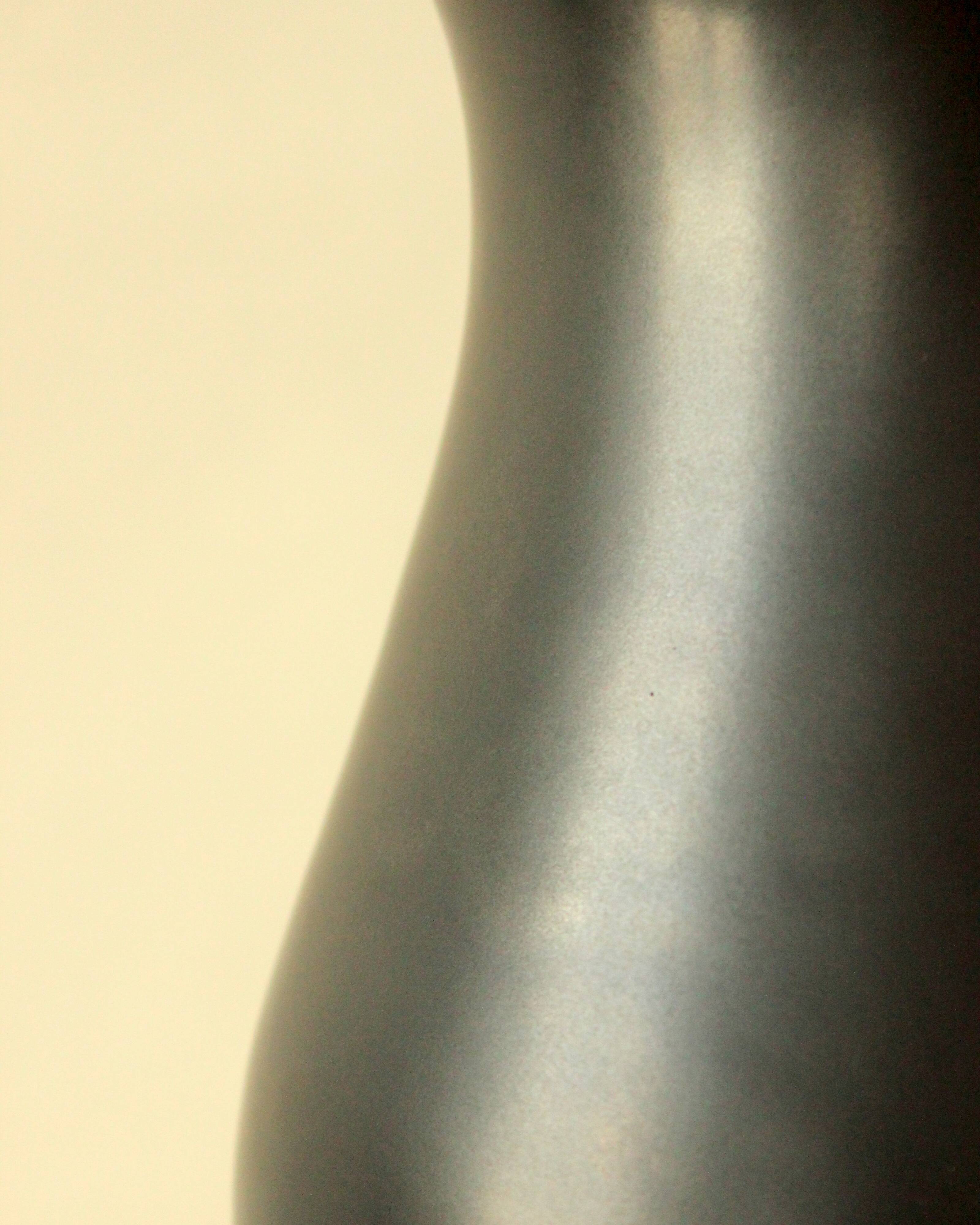 Glazed ceramic vase in black and yellow, in the style of Pol Chambost.