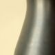 Glazed ceramic vase in black and yellow, in the style of Pol Chambost.