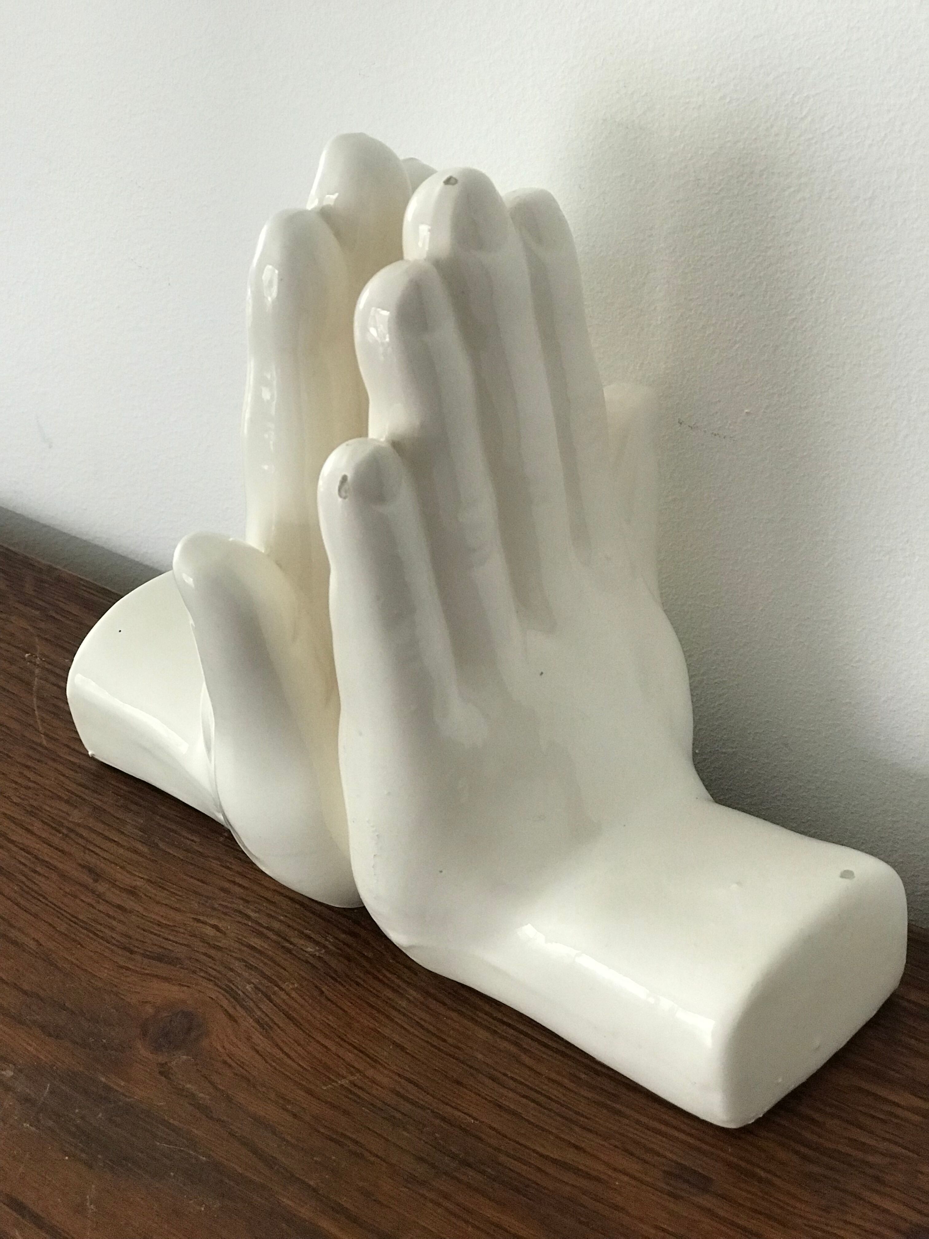 Hands tighten books in ceramics