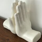 Hands tighten books in ceramics