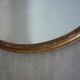 Old gilded wood oval mirror