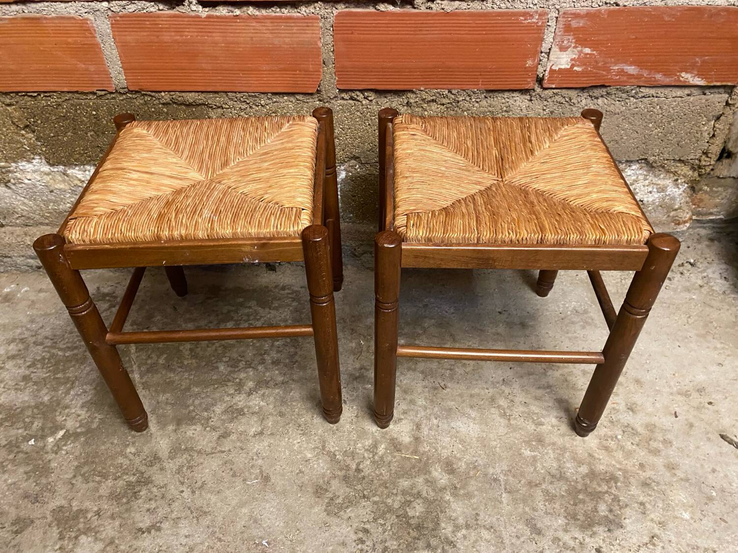 Pair of vintage wooden stools with woven straw seats