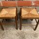 Pair of vintage wooden stools with woven straw seats