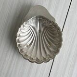 Old metal plate in the shape of a shell.