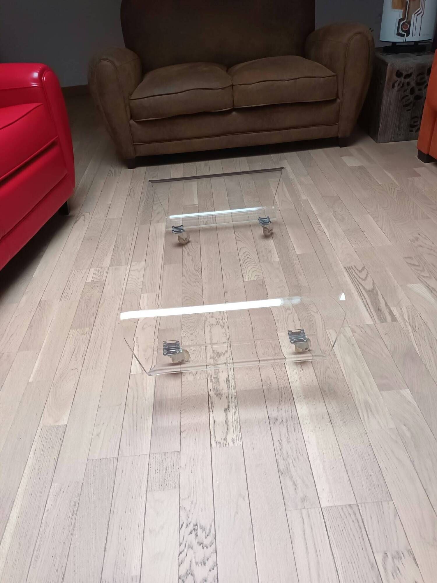 Design coffee table from Habitat in transparent plexiglass, mounted on wheels.