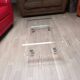 Design coffee table from Habitat in transparent plexiglass, mounted on wheels.