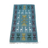 Blue carpet with gazelle patterns woven by hand