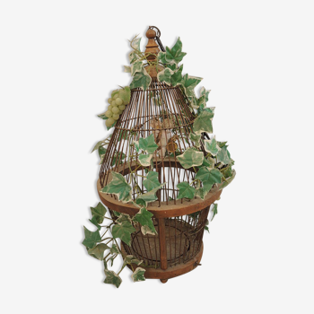 Old decorative bird cage in vegetated rattan