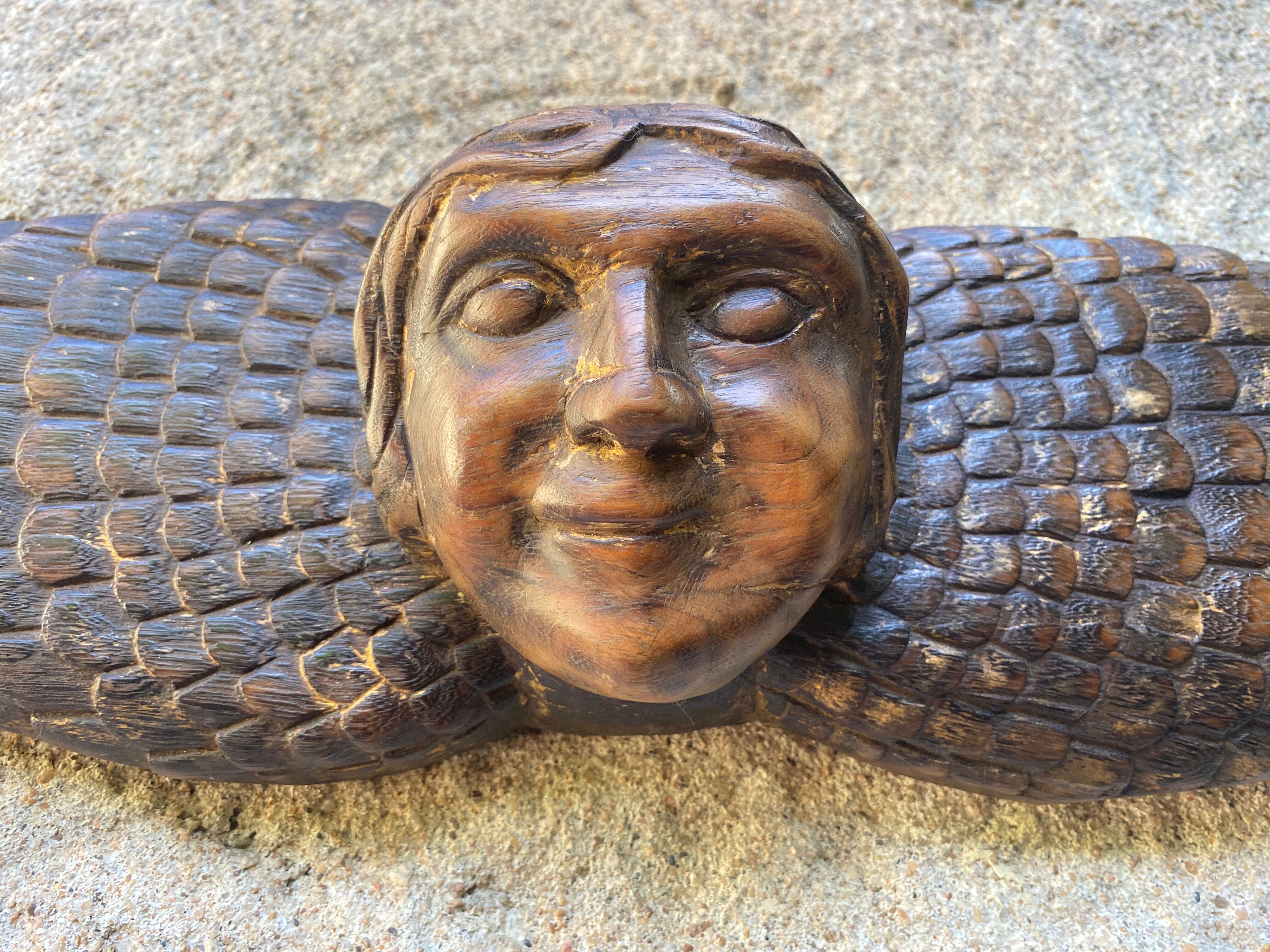 Carved wooden angel head