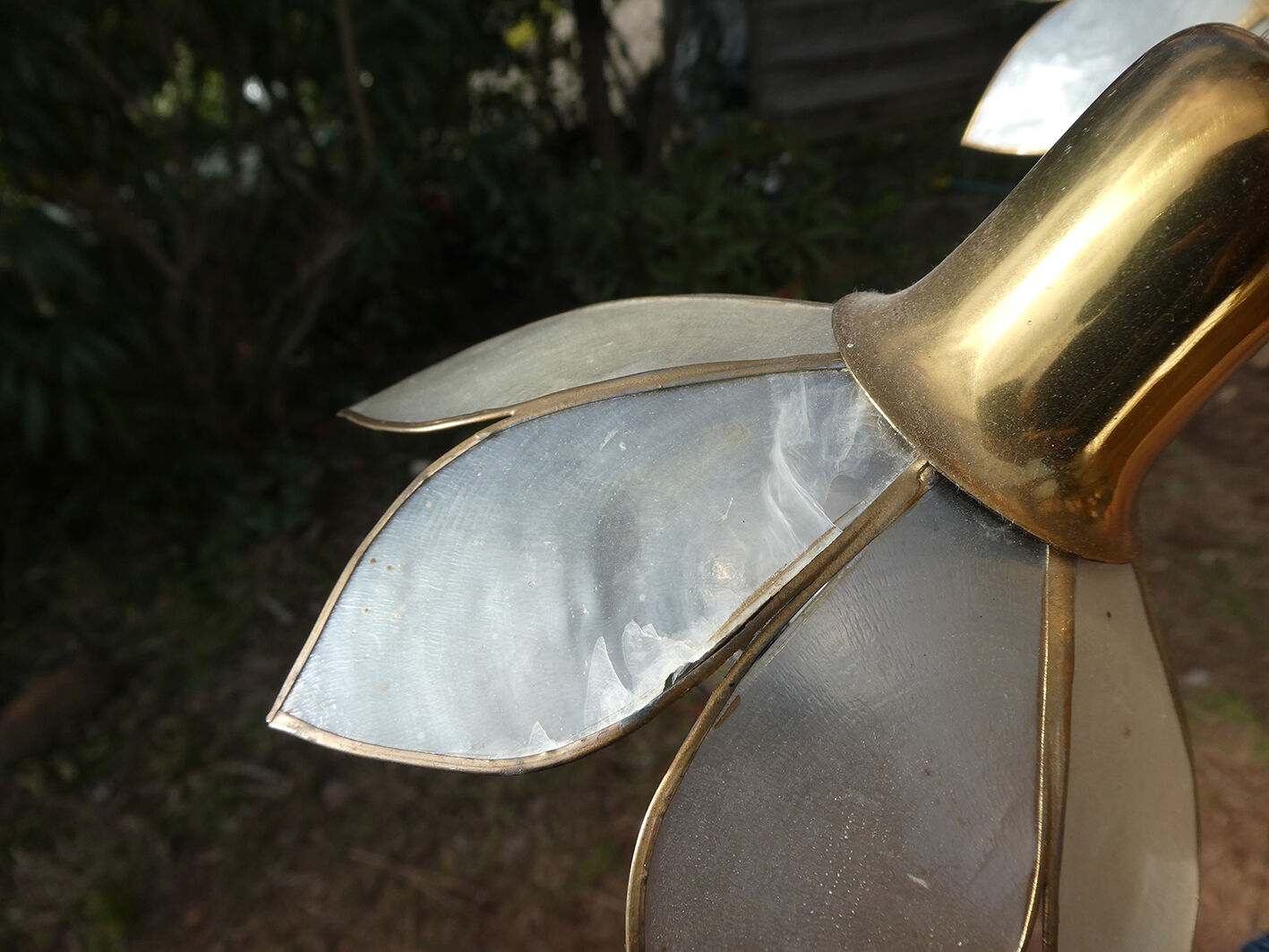 Brass chandelier and flowers in mother-of-pearl petals