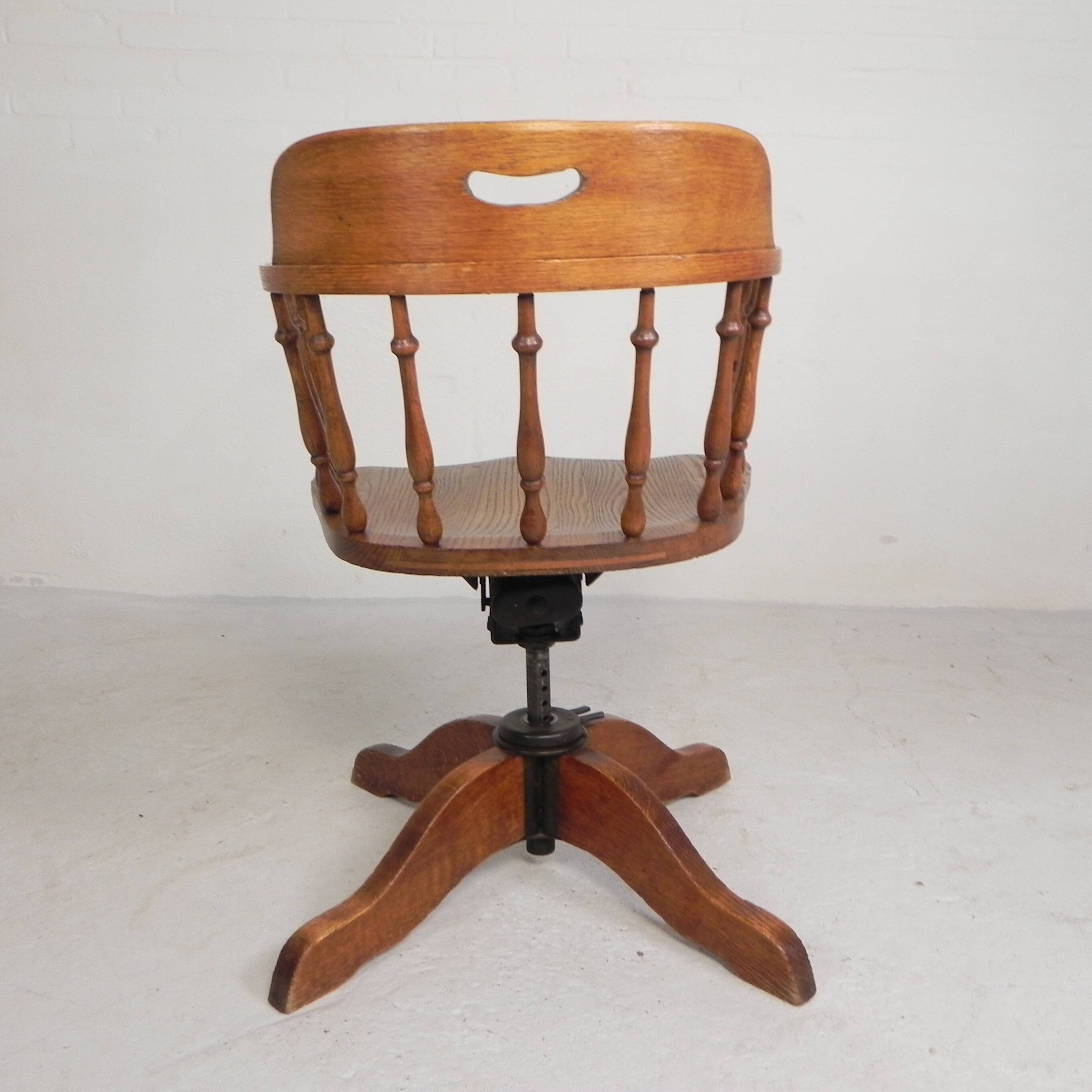 Oak office chair with a spring system and height adjustable, 1930s.