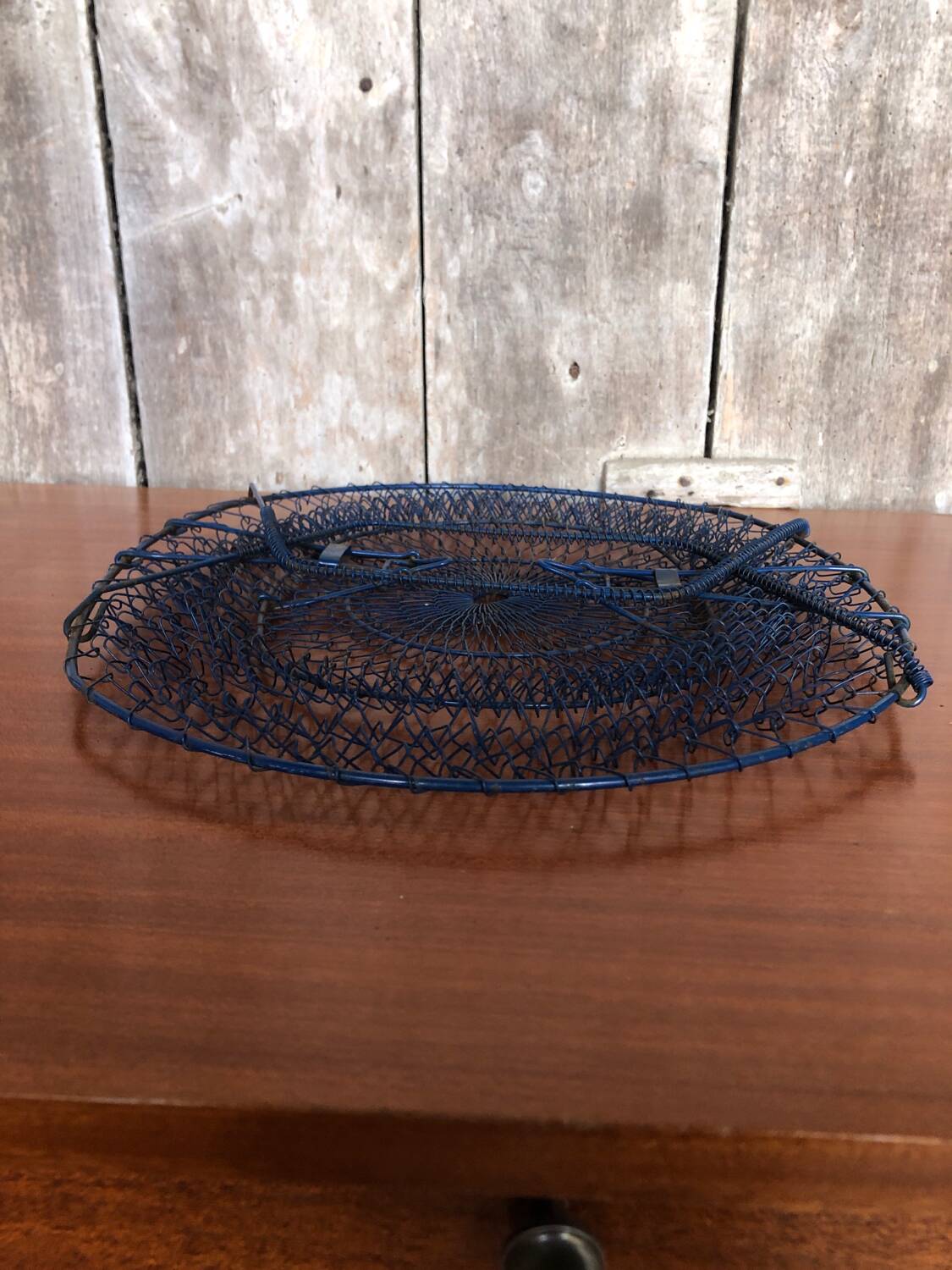 Old foldable blue metal basket, vintage handles