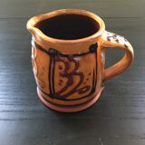 Hand decorated terracotta pitcher