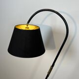 Design floor lamp in black lacquered metal and brass.